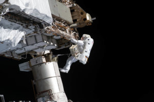 Victor Glover works to upgrade the power system outside the International Space Station. (Courtesy of NASA)