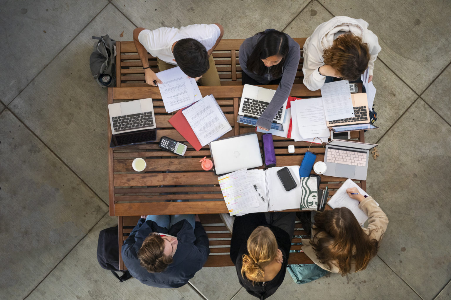 Students study at the tables outside of the Faculty Offices East building.