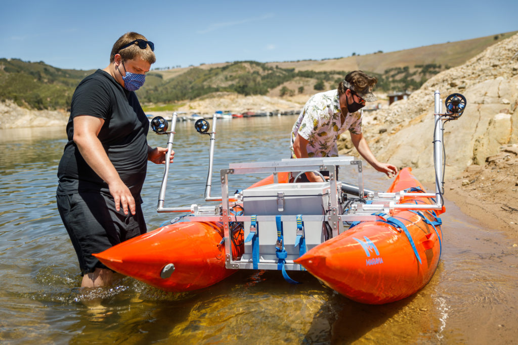 Mechanical engineering students test the research raft they built for their senior project at Lake Nacimiento.