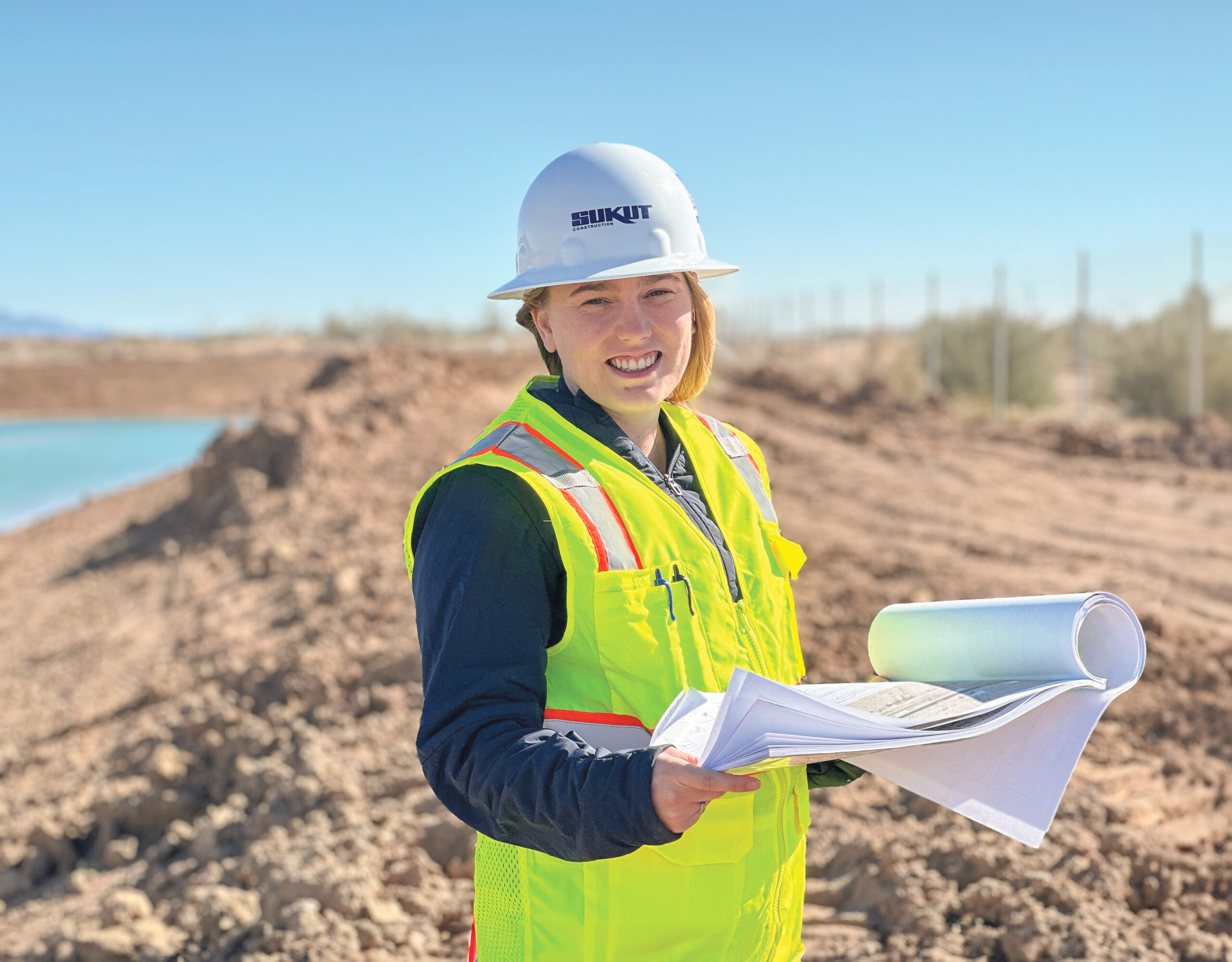 Cal Poly Graduate Sarah Scherzinger reviews plans on-site at the Mid Canal Storage Project in Niland, California.